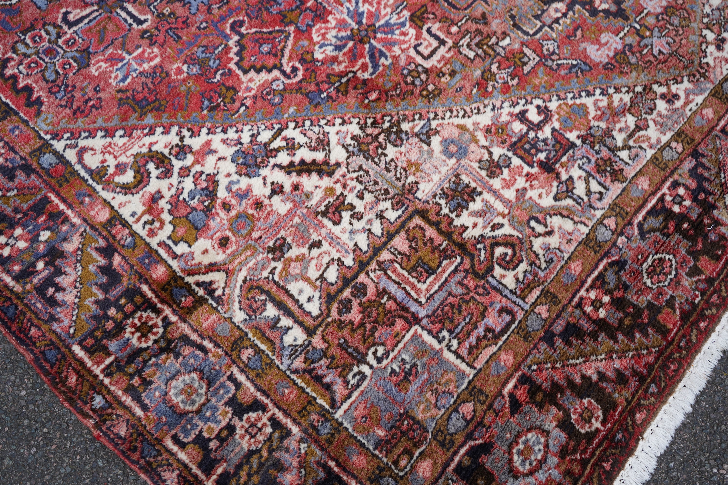 A Heriz brick red ground carpet